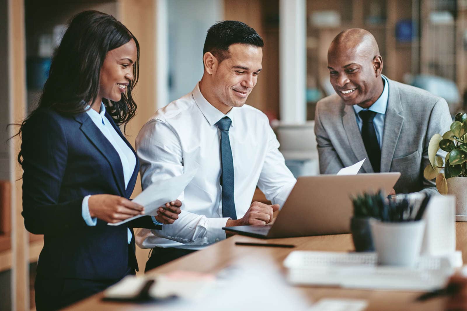 Three lawyers looking at a computer